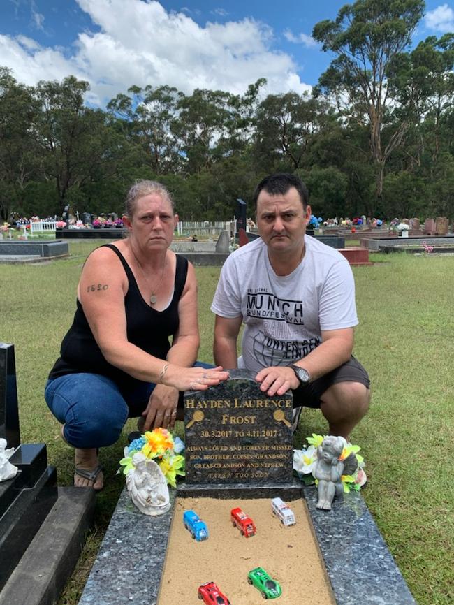 Kathy Hungerford and Darren Mason at the gravesite off their grandson Hayden Frost, who died in 2017 aged just seven months. Supplied.