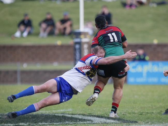 Greg Alderson tackles Colyton forward Andrew Tuliatu. Picture Warren Gannon Photography