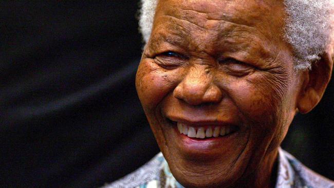 Nelson Mandela smiles at wellwishers as he meets staff from the Robben Island Museum in Cape Town in 2005.