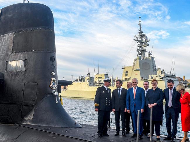 French President Emmanuel Macron (second from left) and then Australian PM Malcolm Turnbull (centre) on a Collins-class submarine operated by the Royal Australian Navy at Garden Island in Sydney in 2018. Picture: AFP