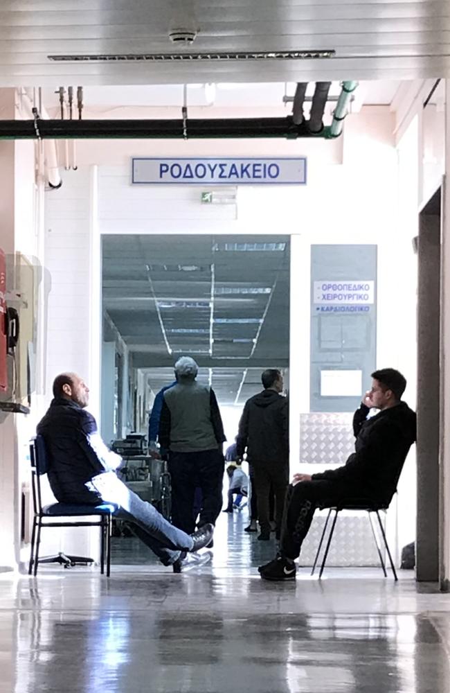 Greek police wait outside the orthopaedic ward in the Asklipieio Hospital in Voula where Jay Malkoun is recovering from surgery. Picture: Rory Mulholland