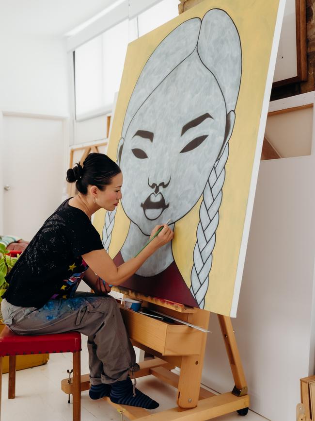 Illuminate Adelaide 2023. Poh Ling Yeow working on one of her paintings featuring The Girl.