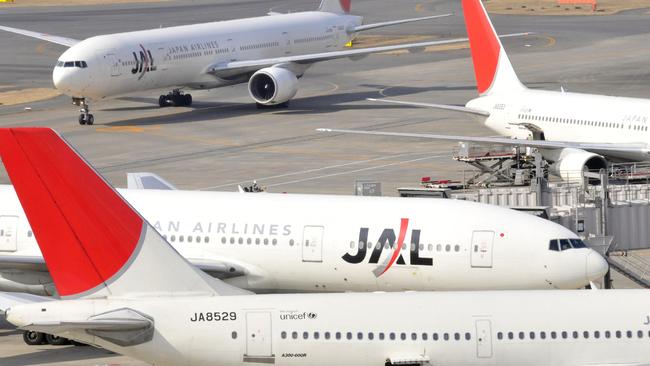 Jetliners from Japan Airlines taxi on the tarmc at Tokyo's Haneda airport.