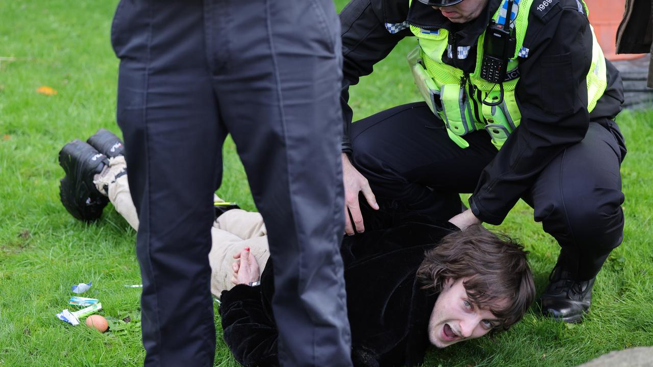 A member of the public is arrested by police after allegedly throwing an egg as King Charles III and Camilla (Photo by Chris Jackson/Getty Images)