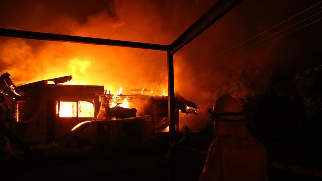 A house on Wakehurst Avenue burns late into Saturday night. Picture: Rohan Kelly