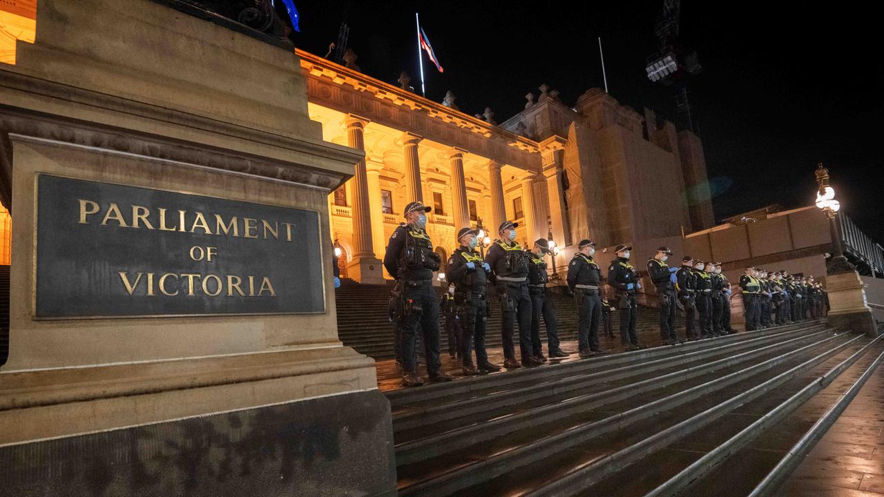 Police lined up outside Parliament House in Melbourne as anti-lockdown protesters marched there. Picture: Tony Gough