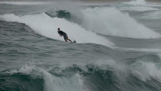 A surfer in big swells at Maroubra Beach in Sydney, NSW. Picture: Dylan Coker