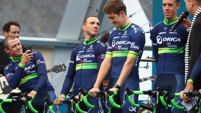 Simon Gerrans (L) of Australia and Orica GreenEdge takes a photo of his team mates during the team presentations ahead of the Tour de France.