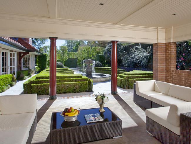 The house features multiple outdoor living areas.