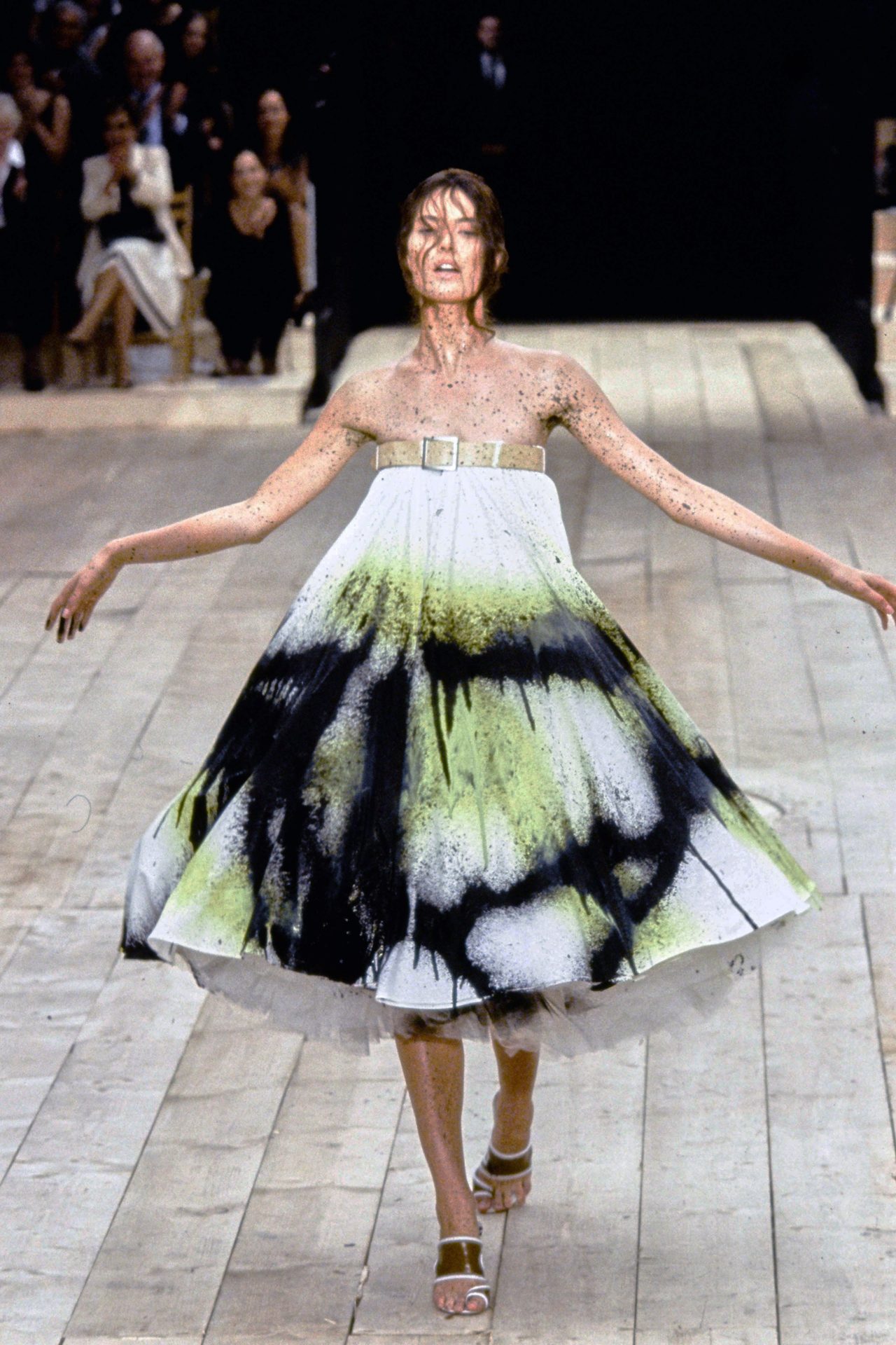 <h2>The unforgettable robotic spray paint at Alexander McQueen spring/summer 1999</h2><p>If we were to list every jaw-dropping and unforgettable runway moment to take place at an Alexander McQueen show, we’d be here a long time, but many would argue the most memorable McQueen moment was the finale at spring/summer 1999. Wearing a wide dress that was initially white, model Shalom Harlow stood on a revolving wheel and was sprayed by two paint guns that jetted black and gold paint to the dress, eliciting applause from the audience.</p>