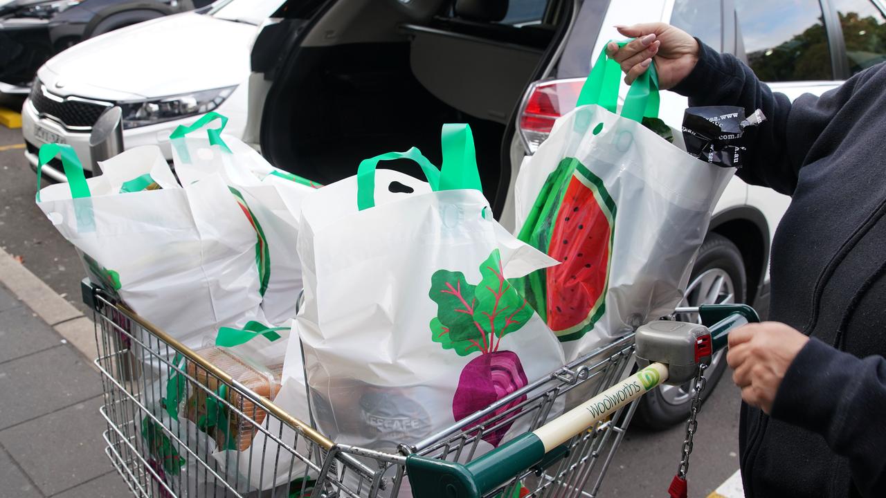 A lady unloads her re-usable plastic bags provided by Woolworths. Picture: AAP Image/Ben Rushton