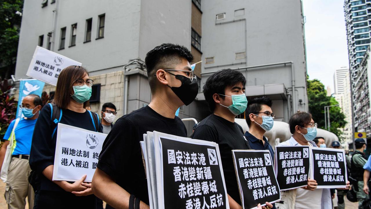 Pro-democracy protesters hold placards that say “Hong Kongers Revolt" as they march from outside the Western Police Station to the Chinese Liaison Office in Hong Kong. Picture: Anthony Wallace/AFP