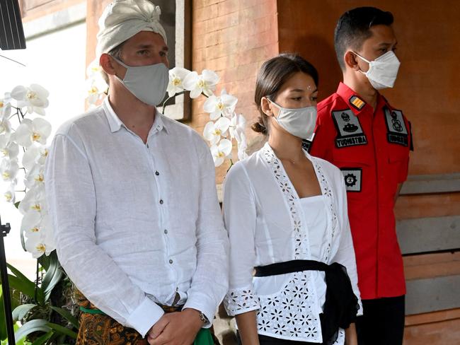 Russia's Alina Fazleeva, centre, and her husband Amdrei Fazleev, left, attend a press conference in Denpasar as they face deportation for taking nude photos on a sacred tree. Picture: AFP