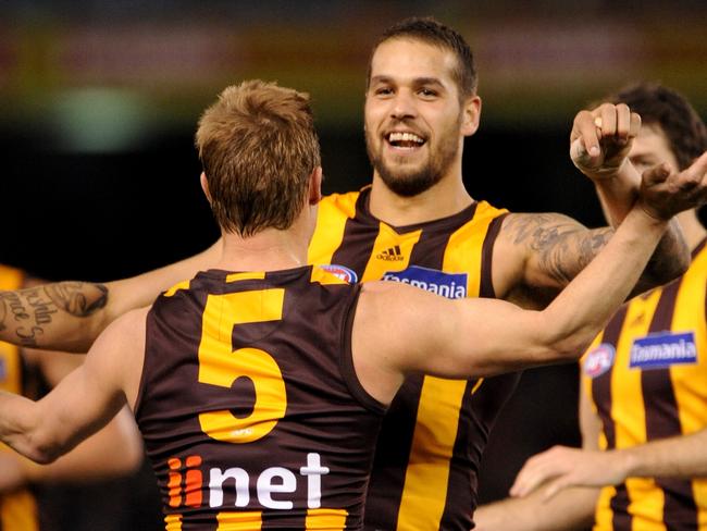 Lance Franklin of Hawthorn celebrates with team-mate Sam Mitchell after Franklin kicked a goal, during the Round 18 AFL match between the Essendon Bombers and the Hawthorn Hawks at Etihad Stadium in Melbourne, Friday, July 26, 2013. Hawthorn defeated Essendon by 22.11.(143) to 13.9.(87). (AAP Image/Joe Castro) NO ARCHIVING, EDITORIAL USE ONLY