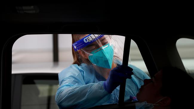 Registered Nurse Ellie Taylor conducts a COVID-19 test.