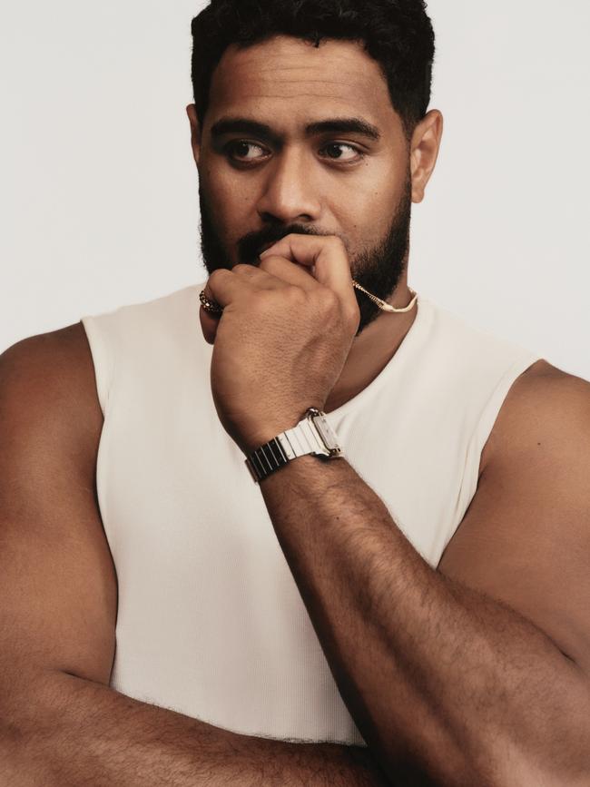 Mailata wears tank top, by Emporio Armani; rose gold Clash de Cartier necklace, ring, stainless steel and yellow gold Santos de Cartier watch, all by Cartier.