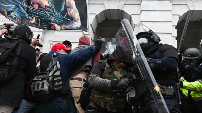 Riot police push back a crowd of Trump supporters after they stormed the Capitol building. Picture: AFP.