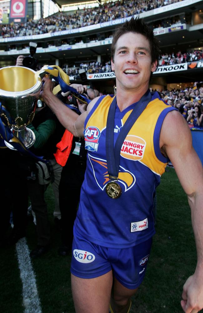 en Cousins celebrates with the AFL Premiership Trophy. Photo by Mark Dadswell/Getty Images.