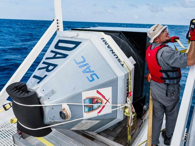 An engineer at the Southeast Asian Fisheries Development Centre works on a tsunami buoy deployment. Picture: AFP