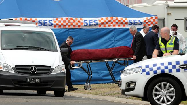 Ms Parrott’s body is removed from the site of the fire. Picture: Alison Wynd