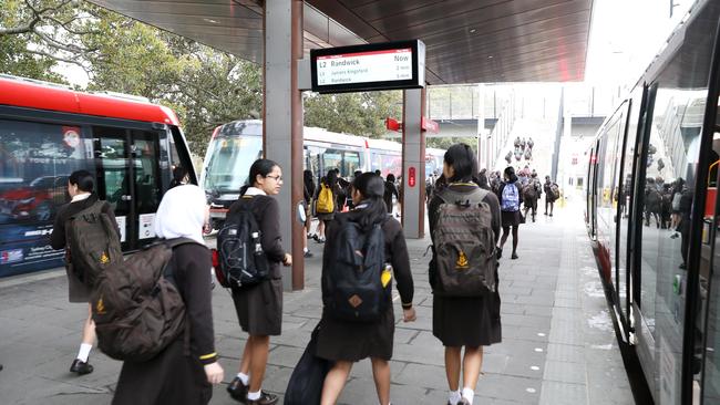 Students leave the light rail at Moore Park on their way to school today. Picture: Getty