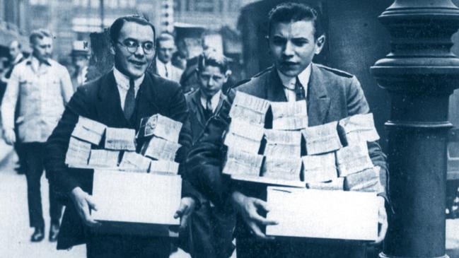 German workers taking home bundles of cash, their daily wage due to inflation during depression of 1920s in Germany.