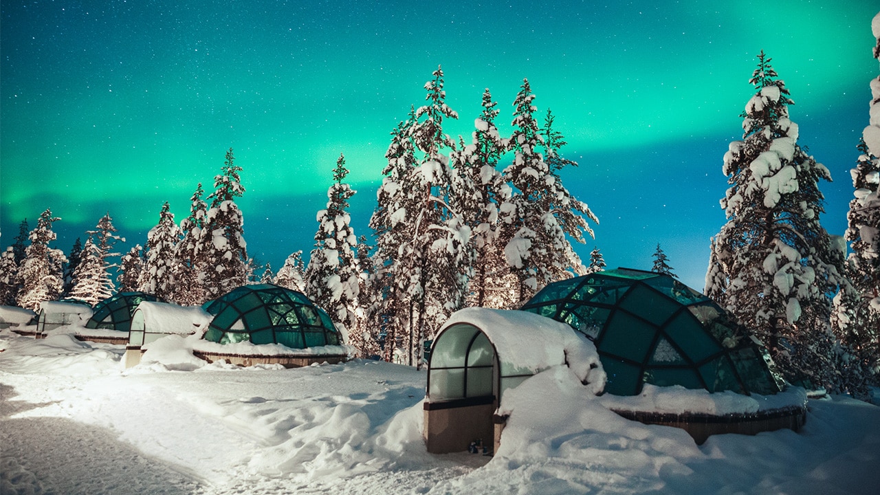 Spend the night under the Northern Lights in a glass igloo at Kakslauttanen Arctic Resort, Lapland, Finland.