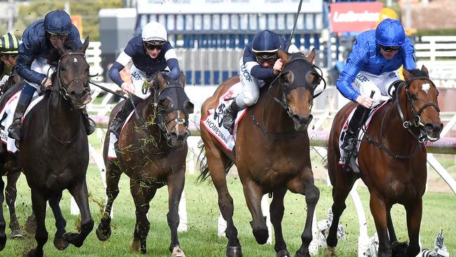 Pat Cosgrave (rail) and Best Solution combine to take out the Caulfield Cup. Picture: Nicole Garmston