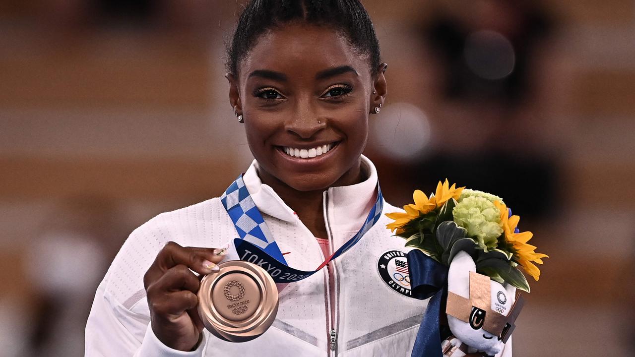 Simone Biles poses with her bronze medal. Picture: Lionel Bonaventure/AFP