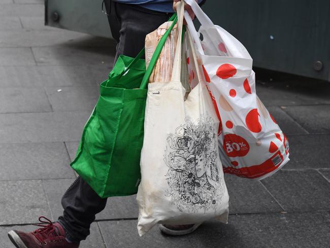 A shopper is seen carrying bags at a Coles Sydney CBD store, Sydney, Monday, July 2, 2018. Woolworths says it will hand out free reusable bags for the next 10 days as its customers get used to its ban on single-use plastic bags. Woolies stores in NSW, Queensland, Victoria and Western Australia stopped providing free single-use plastic bags on June 20. (AAP Image/Peter RAE) NO ARCHIVING