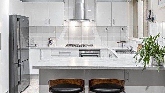 The kitchen finished with stainless steel appliances and a breakfast bench.