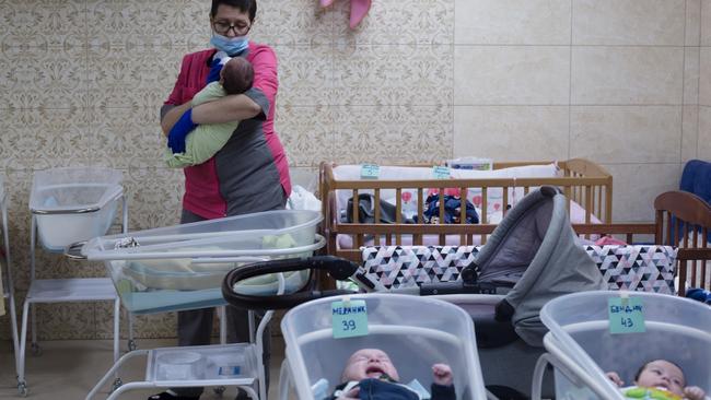 Iryna, a nurse, feeds a baby. Picture: Getty Images