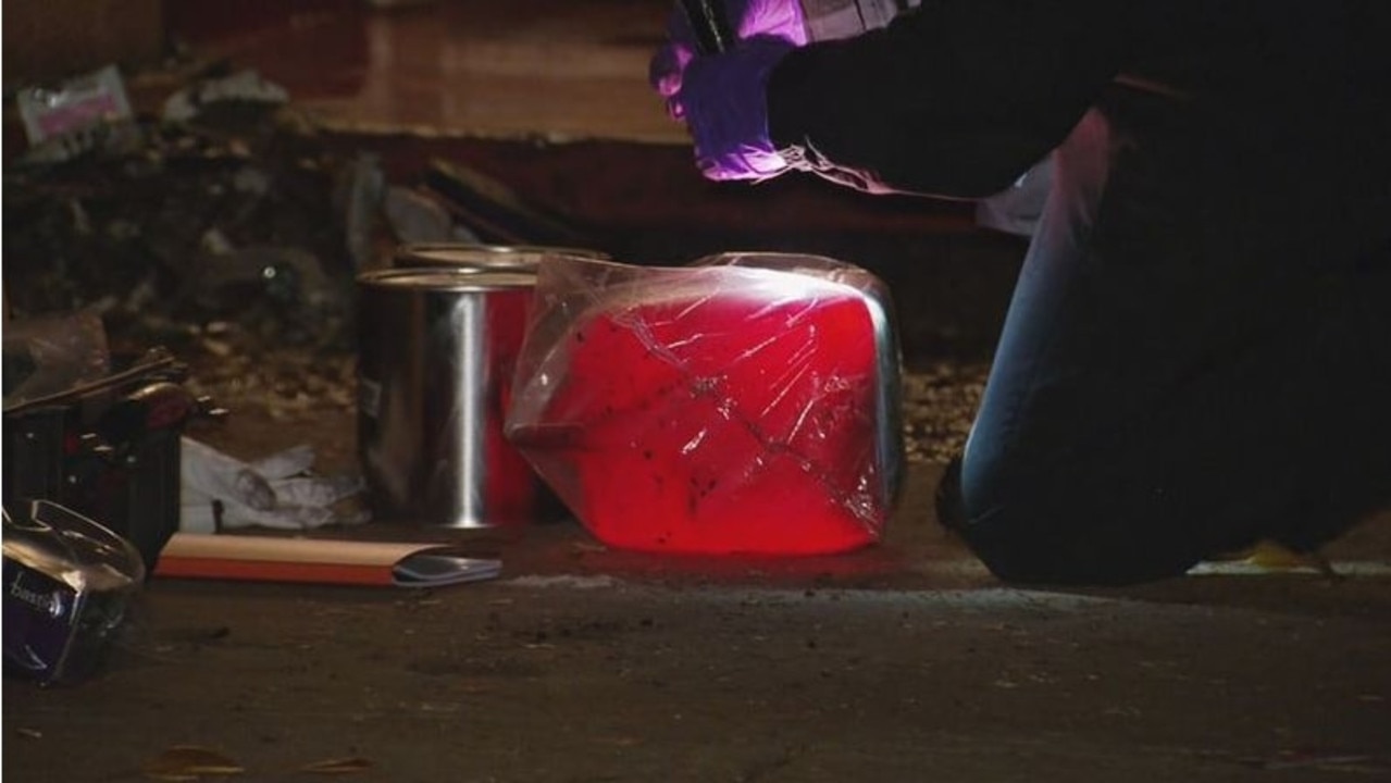 What appears to be a plastic jerry can is examined at the scene. Picture: Nine