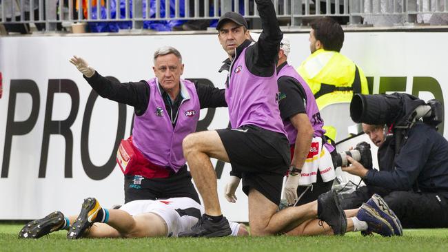 Trainers call for the stretcher after Robbie Gray is knocked out.