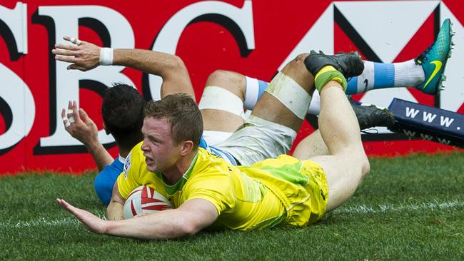 Henry Hutchison of Australia dives over to score a try against Argentina at Hong Kong Stadium.