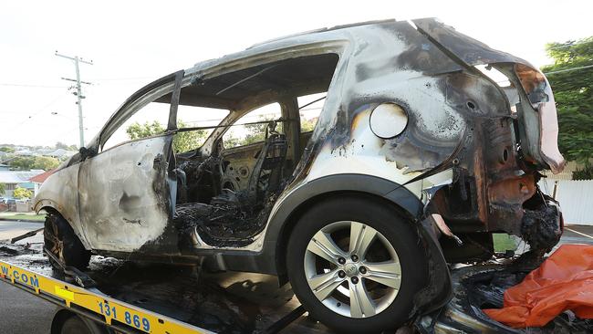 The burnt out car in which three children died is removed from Raven St, Camp Hill. Picture: Lyndon Mechielsen/The Australian