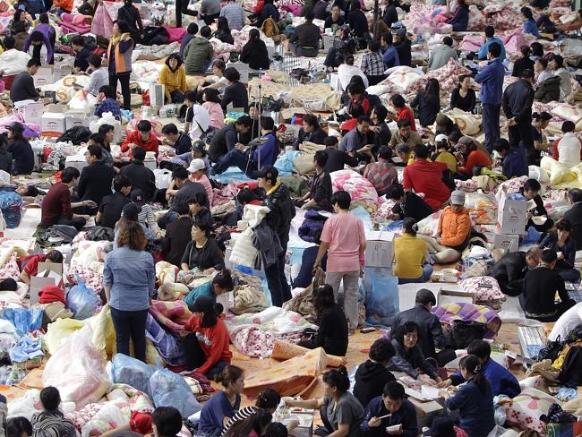 Holding on to hope ... relatives wait for missing passengers of a sunken ferry at Jindo gymnasium. Picture: Chung Sung-Jun