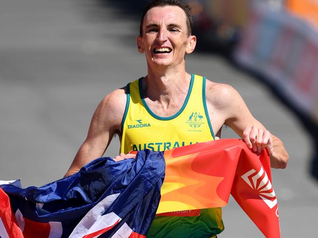 Michael Shelley of Australia crosses the finish line to win the Men's Marathon Final on day eleven of competition on the Gold Coast, Australia, Sunday, April 15, 2018. (AAP Image/Dean Lewins) NO ARCHIVING, EDITORIAL USE ONLY