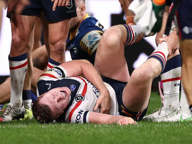 Drew Hutchison reacts after getting smashed in a tackle while a Roosters player. Picture: Getty Images