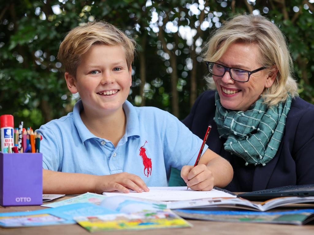 Archie Isaac, 11, with his mum Jenny Atkinson, at home in Manly Vale, today.
(Story about how kids should use old fashioned pen and paper to do writing as it helps develop their skills and boosts their creativity).

Picture: Justin Lloyd.