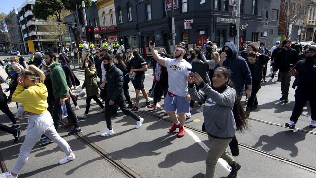 Protesters march in the streets near the market. Picture: NCA NewsWire/David Geraghty