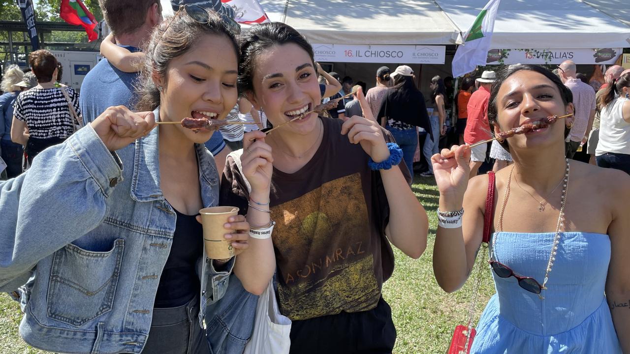 Panmai Rasitanon, Emy Mochi and Eleonora Bianco eating arrosticini at the La Festa - Food and Wine day as part of Cairns Italian Festival at Fogarty Park. Picture: Andreas Nicola