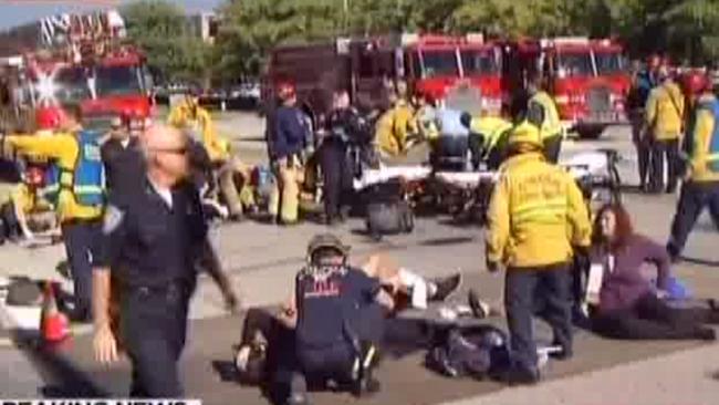 Chaos ... emergency service workers treat victims at the scene of the shooting.