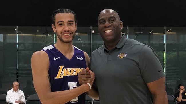 Xavier Cooks pictured with NBA legend Magic Johnson.