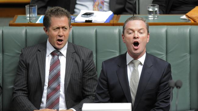 The manager of Opposition business Christopher Pyne (right) and Luke Hartsuyker react during House of Representatives question time at Parliament House in Canberra in 2012. (AAP Image/Lukas Coch).