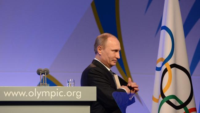 Russian President Vladimir Putin leaves the stage after speaking at an IOC event.