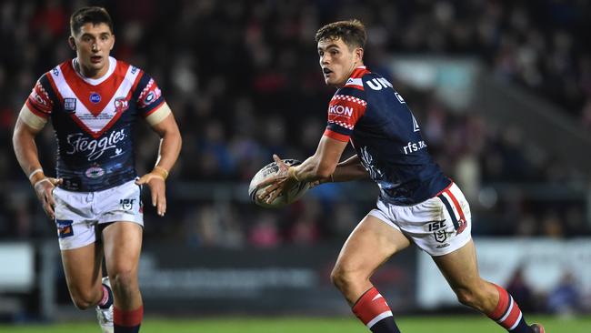 Kyle Flanagan runs the ball against St Helens as Victor Radley watches on during the World Club Challenge clash at Totally Wicked Stadium in England. Picture: Nathan Stirk/Getty