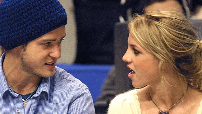 (FILES) Pop superstars Britney Spears (R) and boyfriend Justin Timberlake (L) talk as they sit courtside at the NBA All-Star Game 10 February 2002 in Philadelphia. Britney Spears says in her eagerly anticipated new memoir that she had an abortion during her relationship with Justin Timberlake over two decades ago, according to an excerpt released October 17, 2023. (Photo by TOM MIHALEK / AFP)