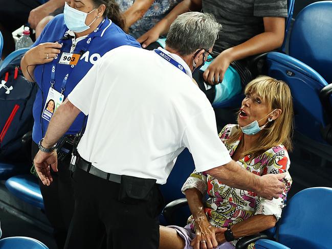 A woman is removed from the arena after play was interrupted in the match between Rafael Nadal and Michael Mmoh on Thursday night. Picture: Getty Images