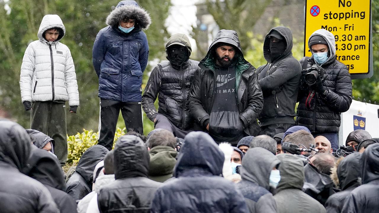 People gather outside the gates of Batley Grammar School in the UK, after a teacher was suspended for showing an image of the Prophet Muhammad in class. Picture: Christopher Furlong/Getty Images